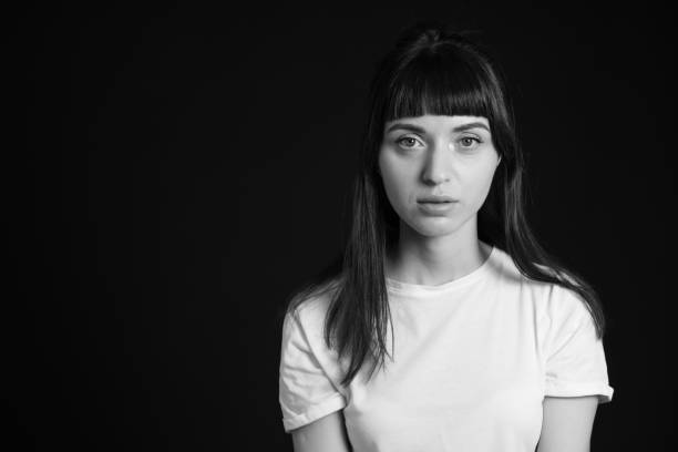 istock Studio portrait of a young woman against plain black background 1283480659