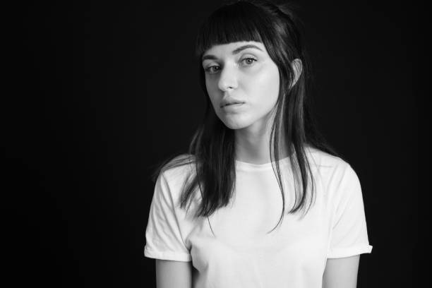 istock Studio portrait of a young woman against plain black background 1283480666