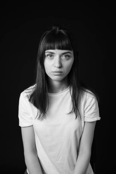 istock Studio portrait of a young woman against plain black background 1283480672