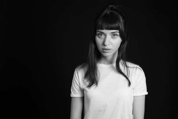 istock Studio portrait of a young woman against plain black background 1283480686