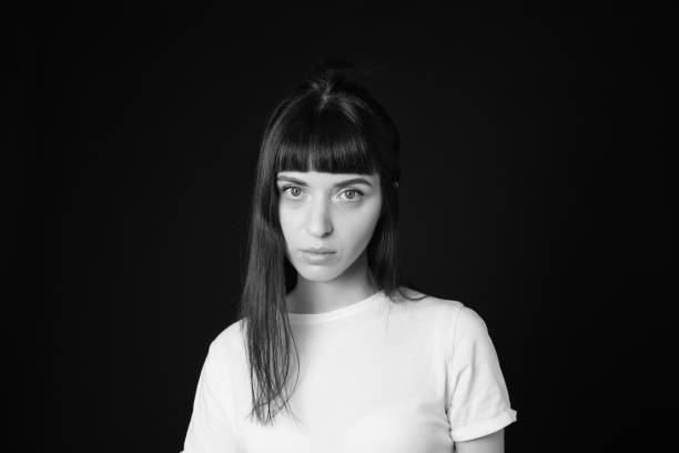 istock Studio portrait of a young woman against plain black background 1283480687