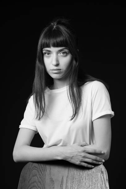 istock Studio portrait of a young woman against plain black background 1283480703