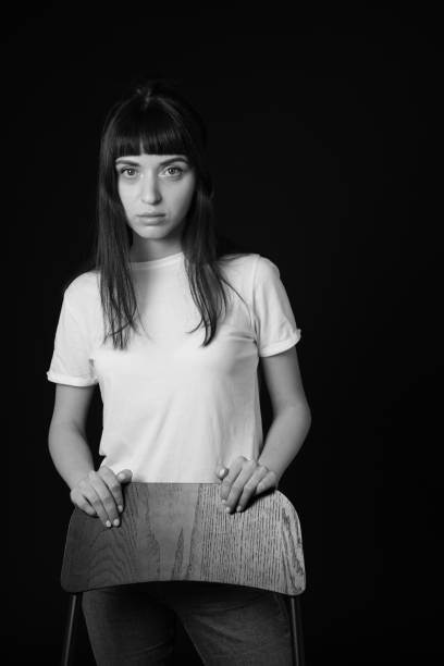 istock Studio portrait of a young woman against plain black background 1283480706