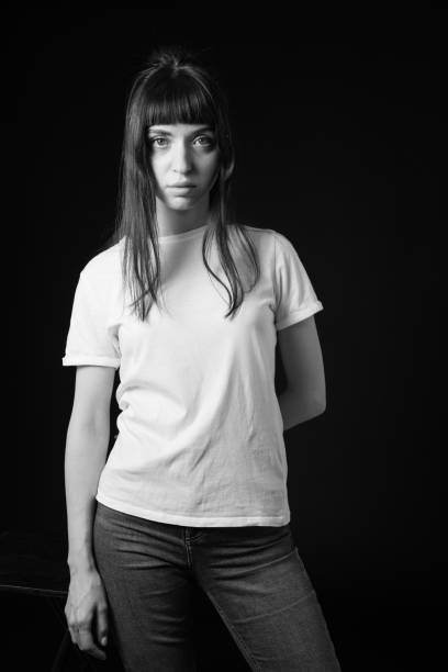 istock Studio portrait of a young woman against plain black background 1283480715