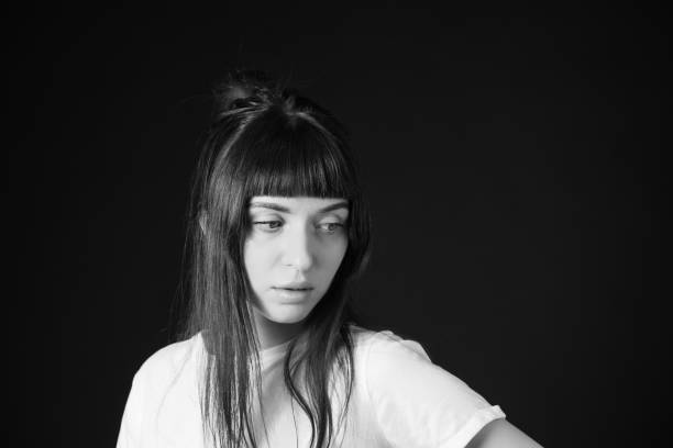 istock Studio portrait of a young woman against plain black background 1283480717