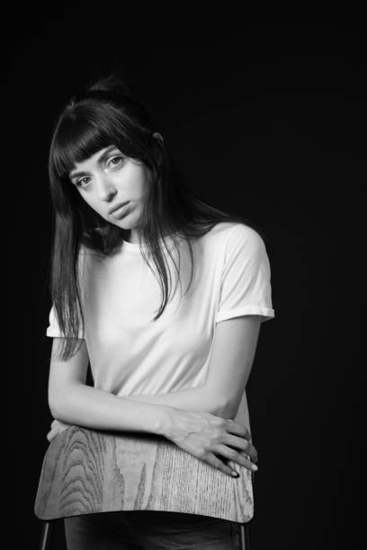 istock Studio portrait of a young woman against plain black background 1283480724