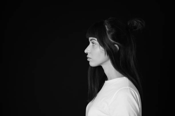 istock Studio portrait of a young woman against plain black background 1283480730