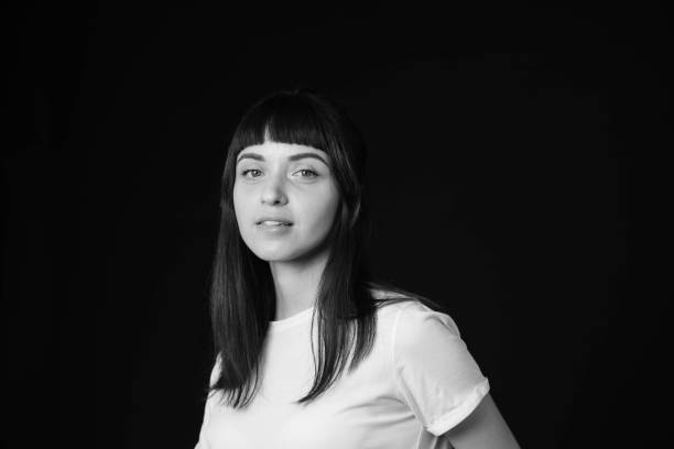 istock Studio portrait of a young woman against plain black background 1283480747