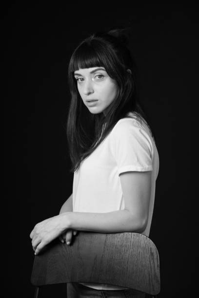 istock Studio portrait of a young woman against plain black background 1283480763