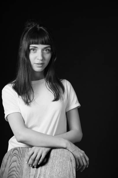 istock Studio portrait of a young woman against plain black background 1283480772