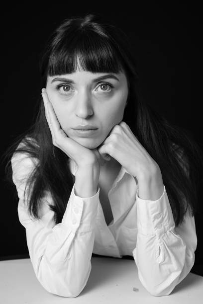 istock Studio portrait of a young woman against plain black background 1283480781