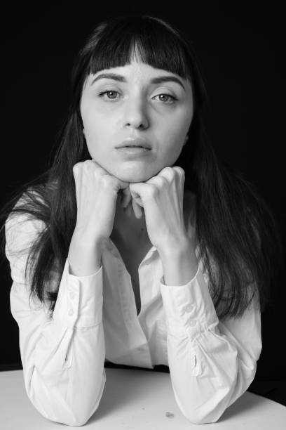 istock Studio portrait of a young woman against plain black background 1283480782