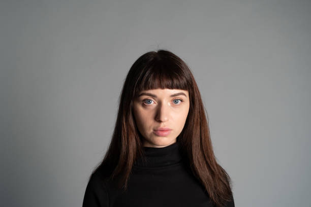 istock Studio portrait of a young woman against plain grey background 1283480862