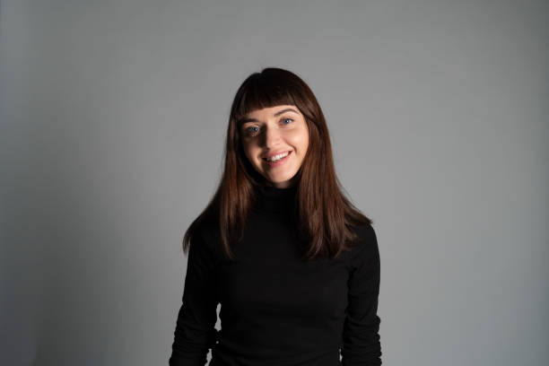 istock Studio portrait of a young woman against plain grey background 1283480864
