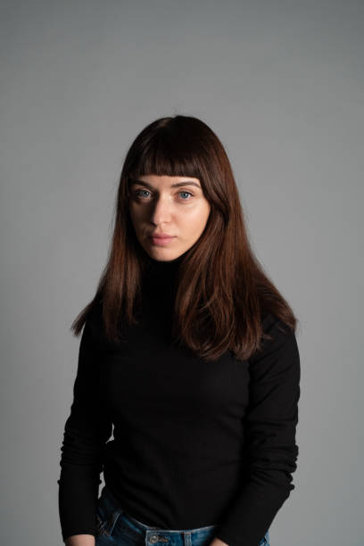 istock Studio portrait of a young woman against plain grey background 1283480867