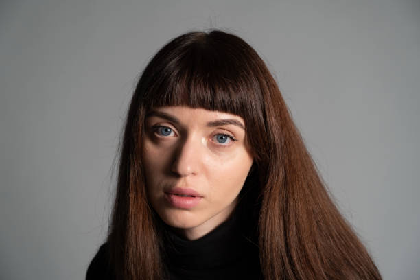 istock Studio portrait of a young woman against plain grey background 1283480876