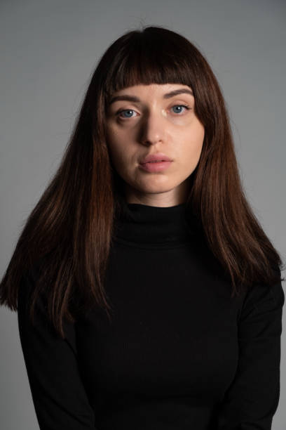 istock Studio portrait of a young woman against plain grey background 1283480877