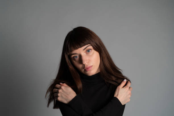istock Studio portrait of a young woman against plain grey background 1283480879