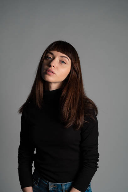 istock Studio portrait of a young woman against plain grey background 1283480884