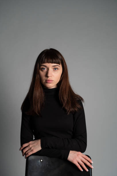 istock Studio portrait of a young woman against plain grey background 1283480888