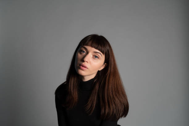 istock Studio portrait of a young woman against plain grey background 1283480891