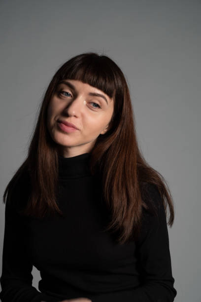 istock Studio portrait of a young woman against plain grey background 1283480898