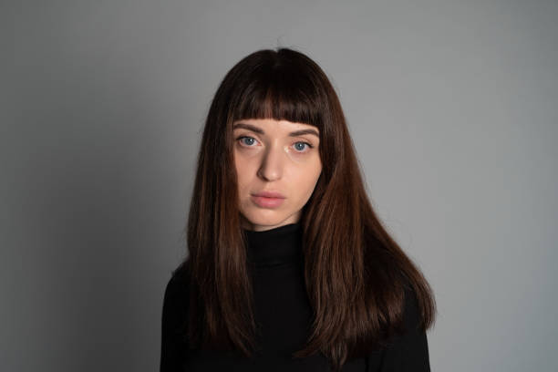 istock Studio portrait of a young woman against plain grey background 1283480899