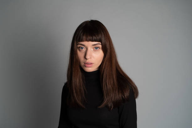 istock Studio portrait of a young woman against plain grey background 1283480904