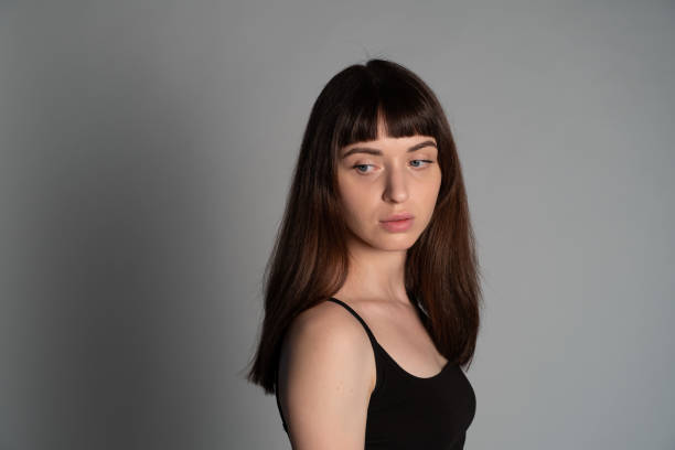 istock Studio portrait of a young woman against plain grey background 1283480914