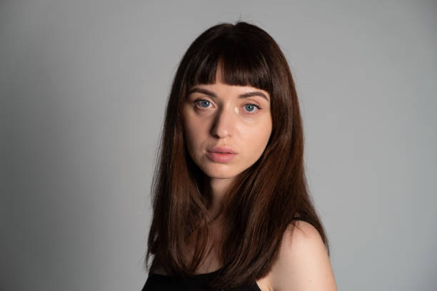 istock Studio portrait of a young woman against plain grey background 1283480915