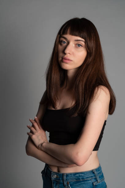 istock Studio portrait of a young woman against plain grey background 1283480921