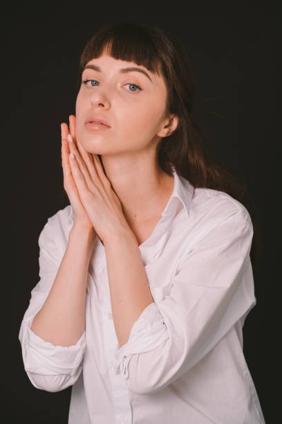 istock Studio portrait of a young woman against plain black background 1283481043