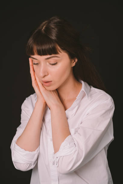 istock Studio portrait of a young woman against plain black background 1283481044