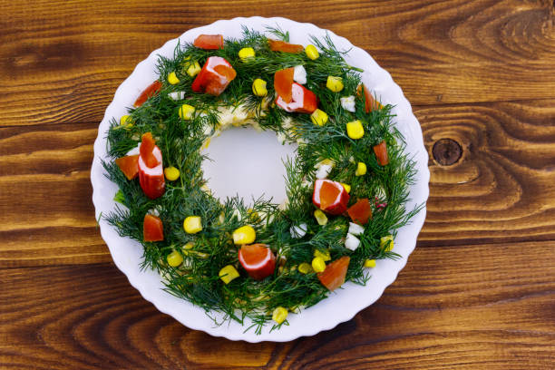 istock Salad Christmas wreath on a wooden table. Top view 1283481605