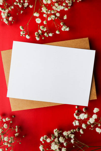 istock envelope and white flowers on a red background 1283482531