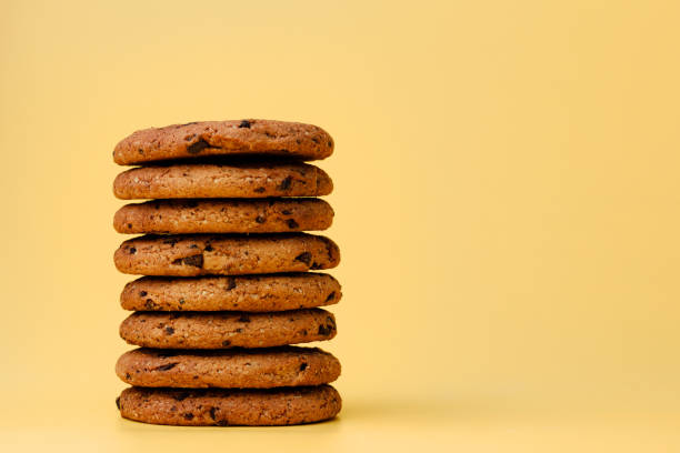 istock Pile of chocolate chip cookies on yellow backgreound 1283482652