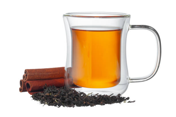 istock Glass cup of tea and cinnamon sticks isolated on white 1283483145