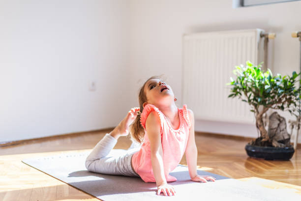 istock Little girl practicing yoga at home 1283484256
