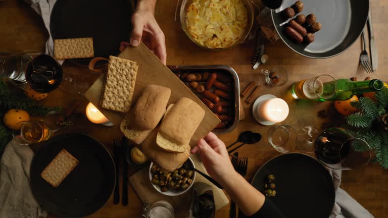 A family enjoying a vegan Christmas dinner together. Seen from above in 4K resolution.