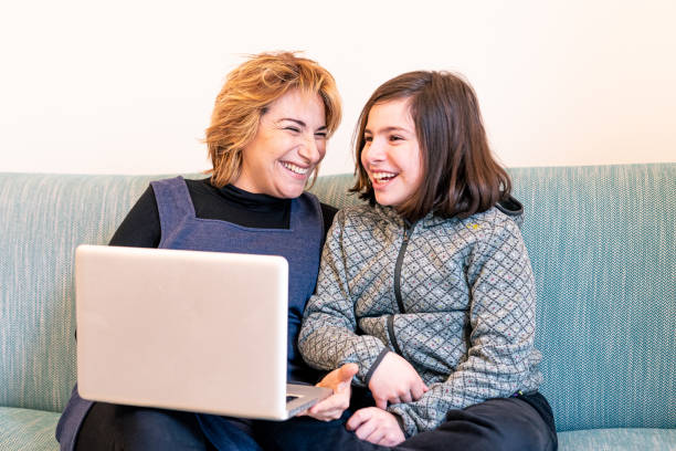 istock happy mother uses modern technology and online tools to entertain her daughter in quarantine, homeschooling concept, having fun watching multimedia content, learning on line in outbreak times 1283484534