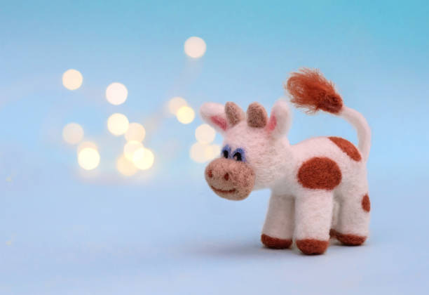 istock Felt toy bull on a blue background with bokeh 1283484636