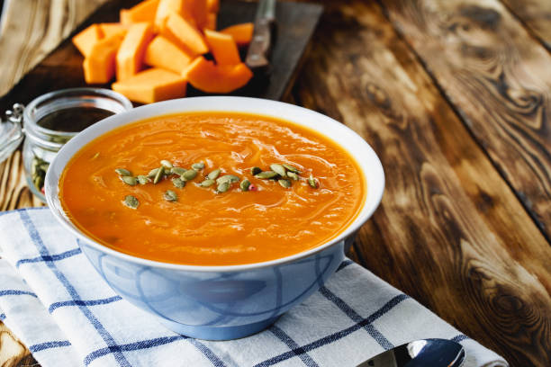 istock Creamy pumpkin soup on a wooden table 1283484847