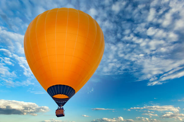 istock Orange balloon against the blue sky 1283485530