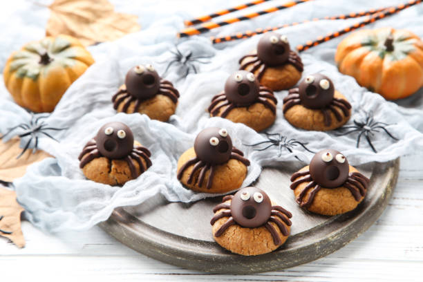 istock Halloween cookies with chocolate spiders on wooden background 1283486120