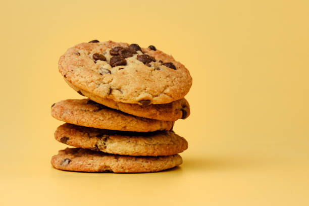 istock Pile of chocolate chip cookies on yellow backgreound 1283488422