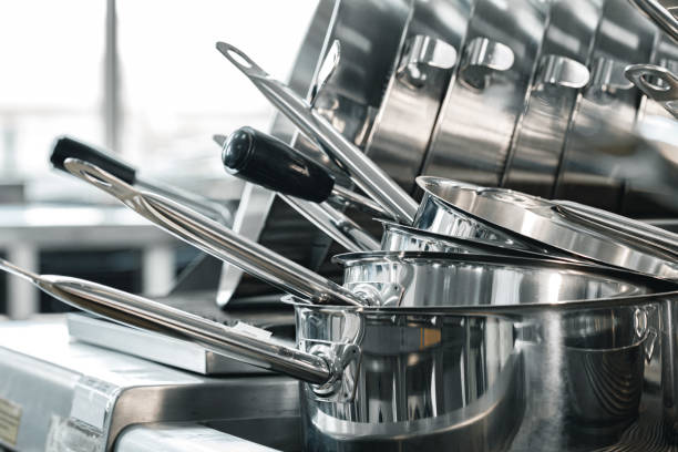 istock Stacked industrial metal cooking pots on proffesional kitchen 1283489010