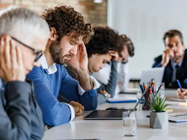 Photo of Business people feeling displeased on a meeting in the office.