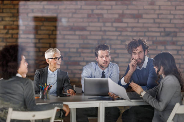 istock Business team working on reports during a meeting in the office. 1283490096