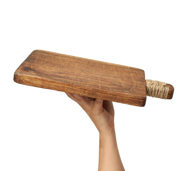 istock woman holding blank brown rectangular wooden board in hand 1283491345