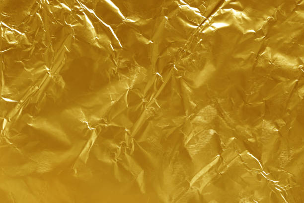istock Gold foil leaf shiny texture, abstract yellow wrapping paper for background and design art work. 1283491808